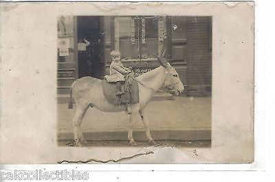 RPPC-Small Child Riding Donkey in Front of a Store - Cakcollectibles