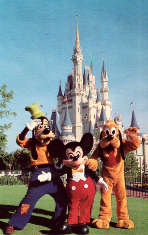 Mickey Mouse,Goofy and Pluto by Cinderella Castle.Vintage postcard front